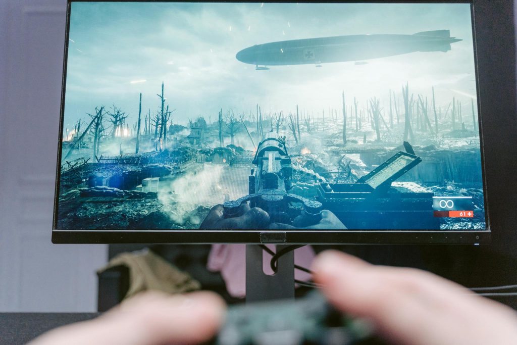 Person Holding White Plane Photo a Defiant Gamer, gaming blog